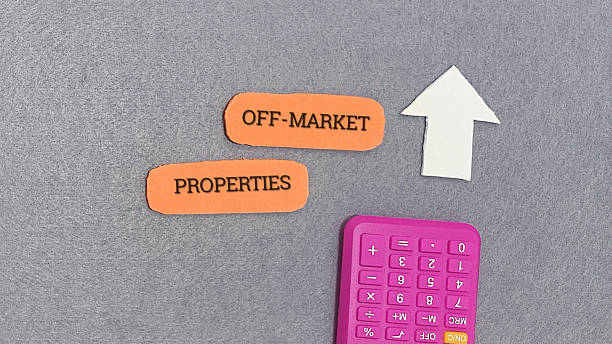 Off-market properties concept with calculator and upward arrow on gray background